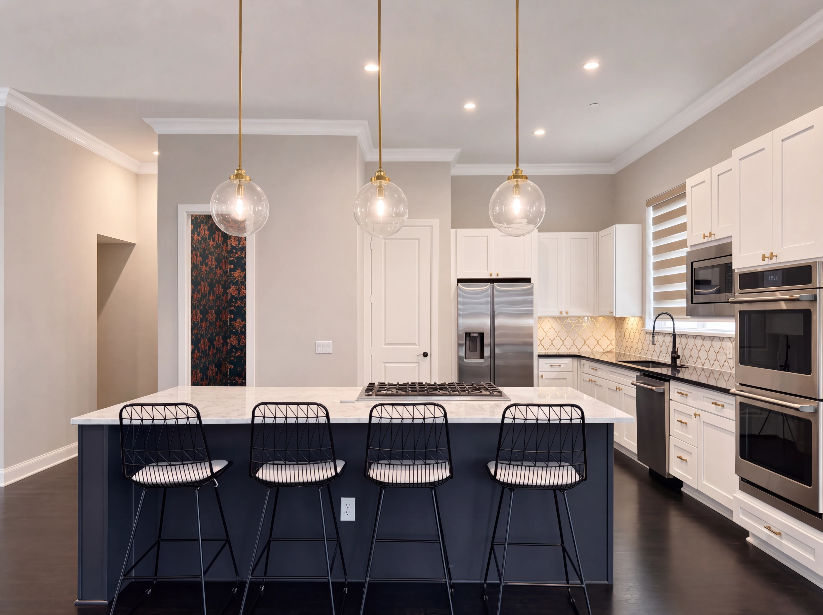 Kitchen with navy island and globe pendants