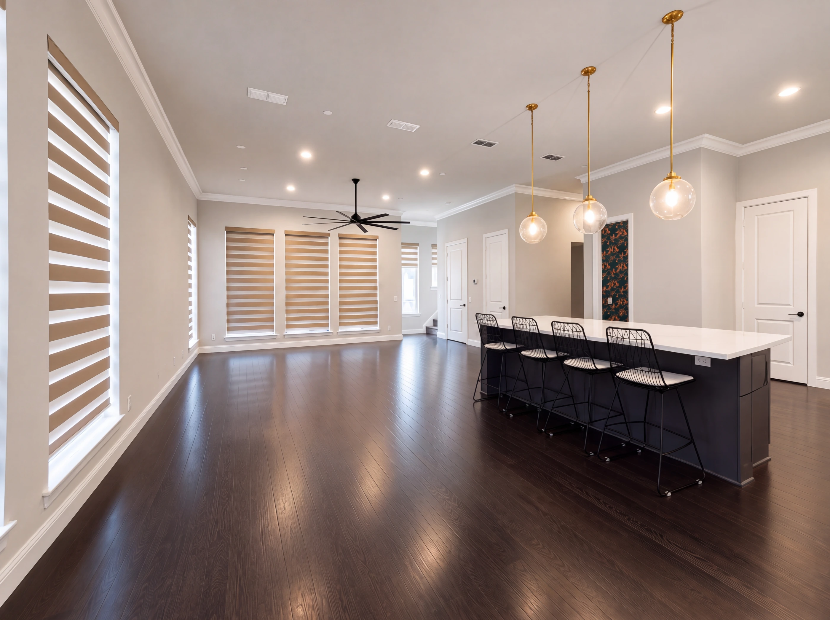 Open living level with hardwood floors and kitchen island
